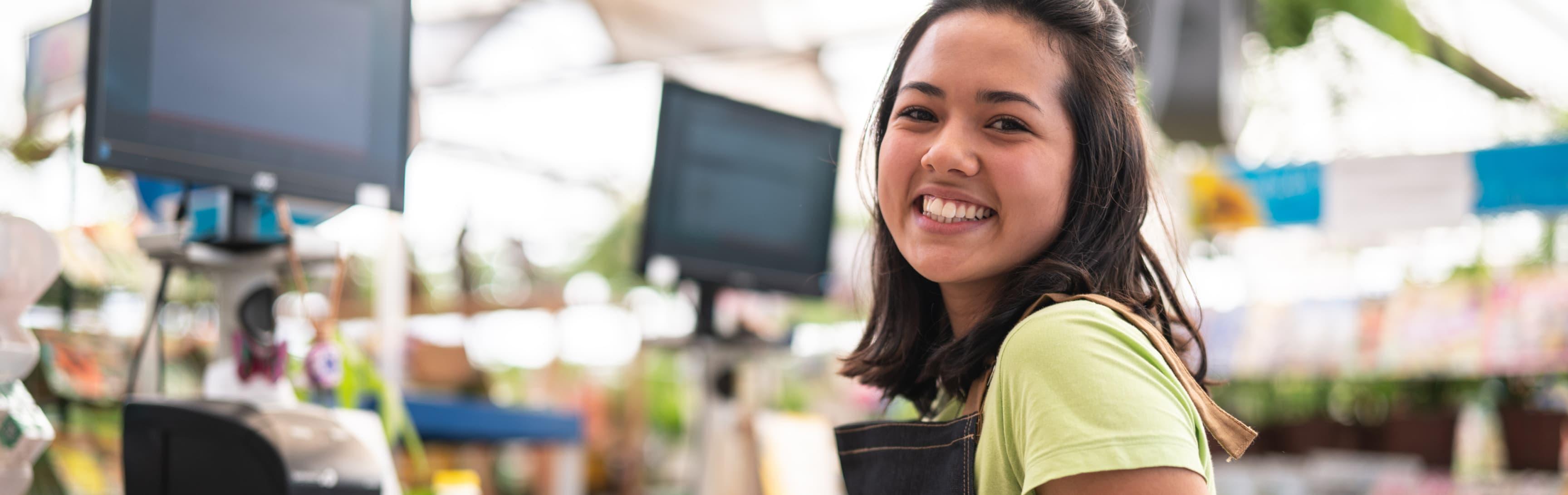 a cashier smiling into the camera